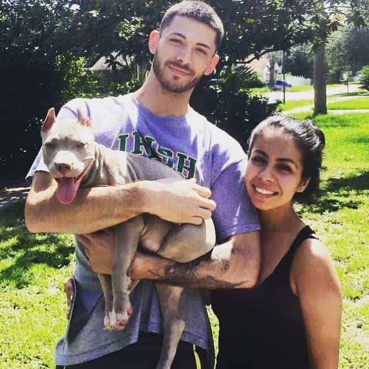 family with pitbull dog